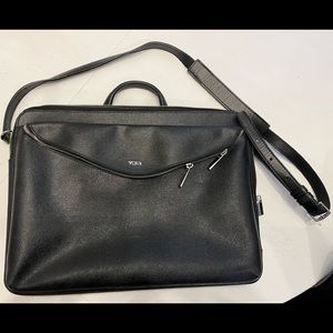 TUMI laptop carrier - coated black leather wipes clean easily. Great condition!